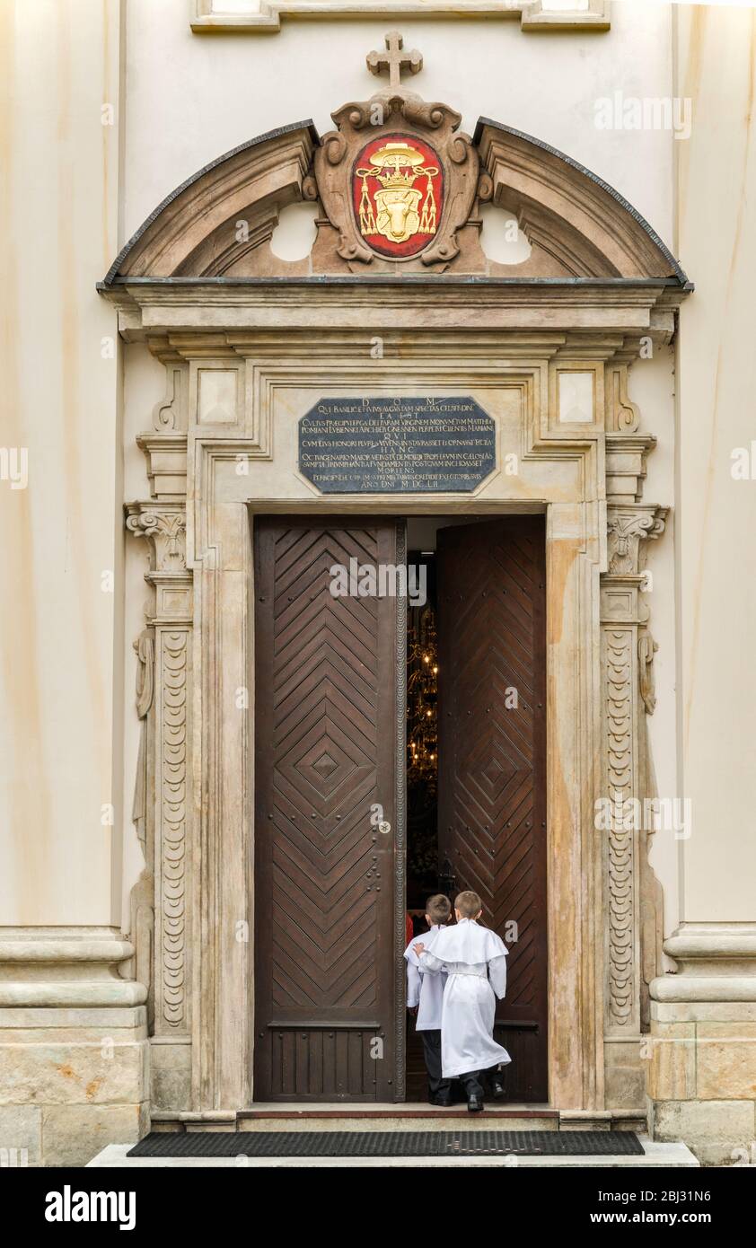 Boys entering church for First Holy Communion event, Cathedral Basilica in Lowicz, Mazovia, Poland Stock Photo