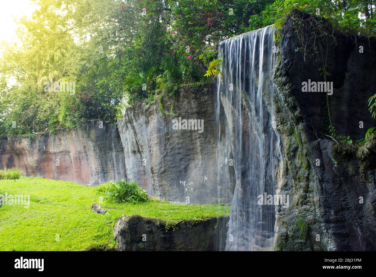 beautiful, serene, waterfall with sunlight rays in the forest Stock Photo