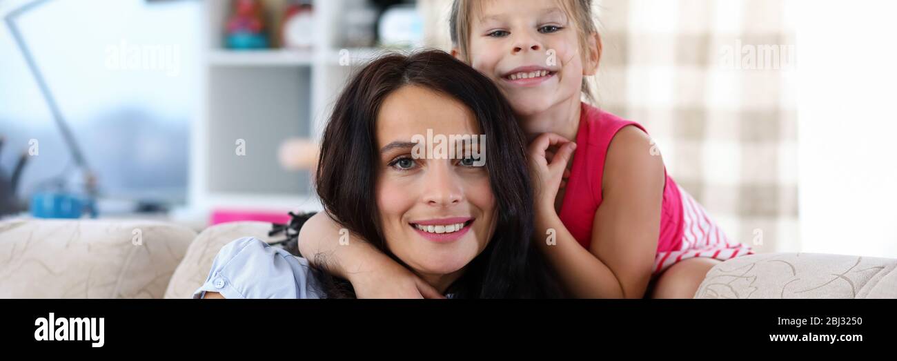 Daughter hugging mother Stock Photo