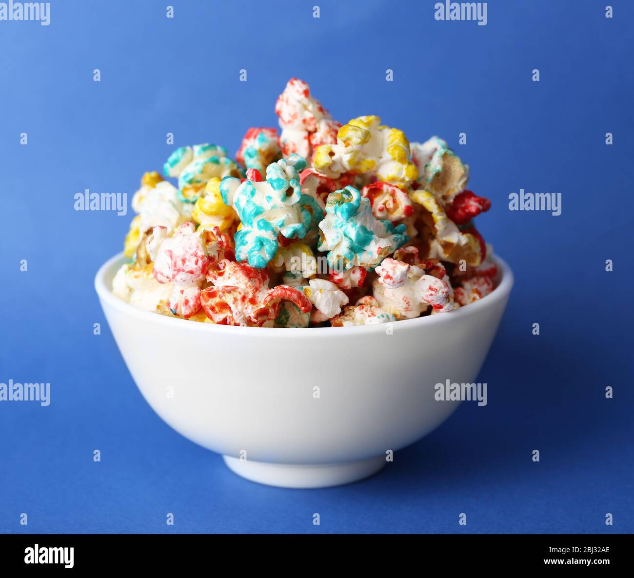 Sweet colourful popcorn on blue background Stock Photo