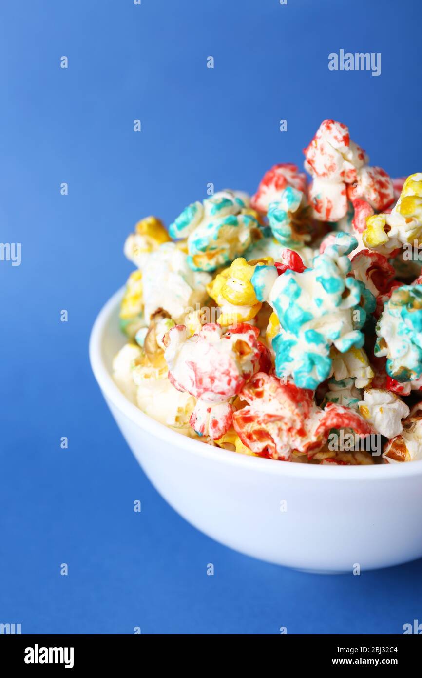 Sweet colourful popcorn on blue background Stock Photo