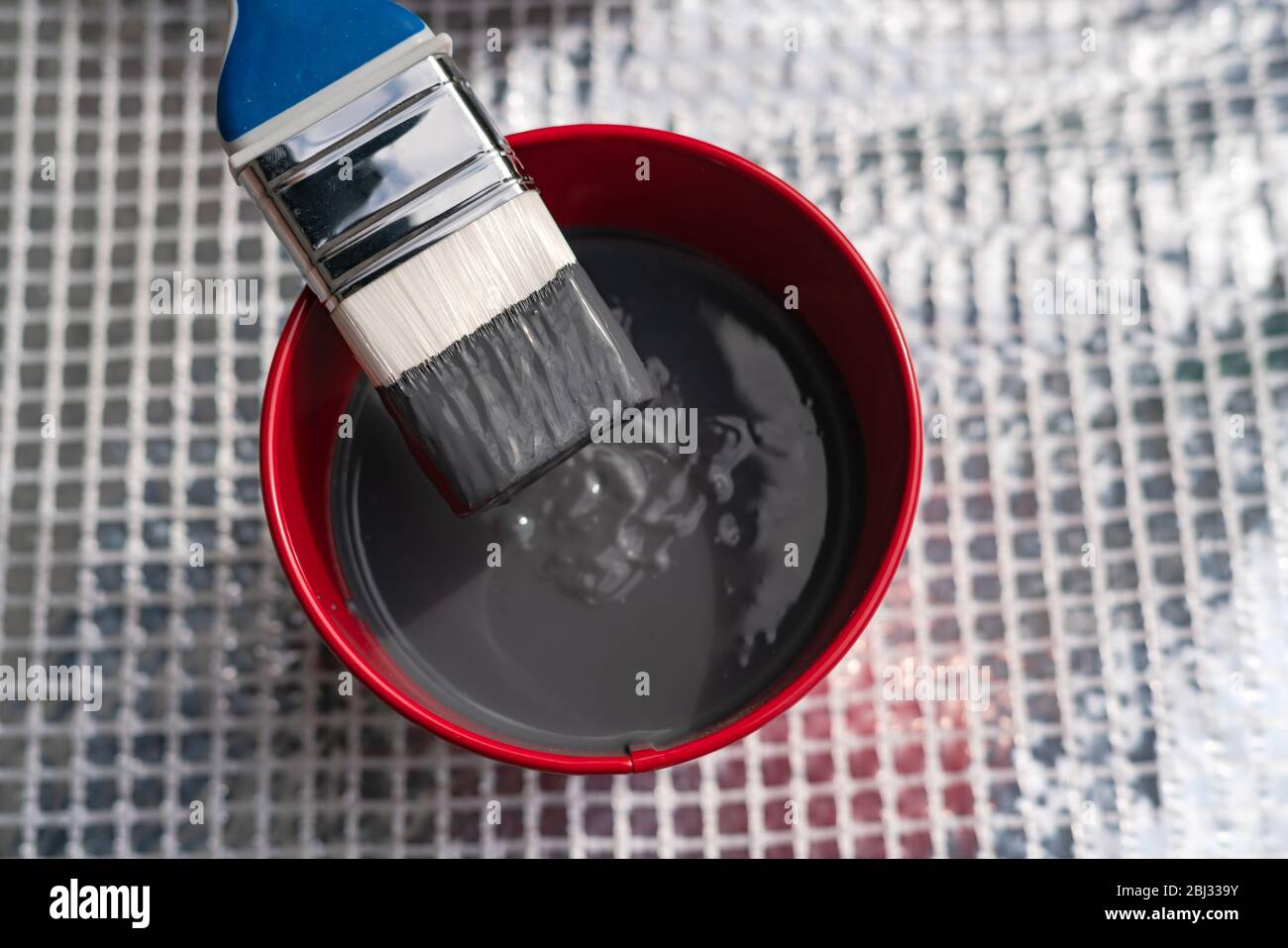 Paint brush and a bucket with paint still life. Painting house outside