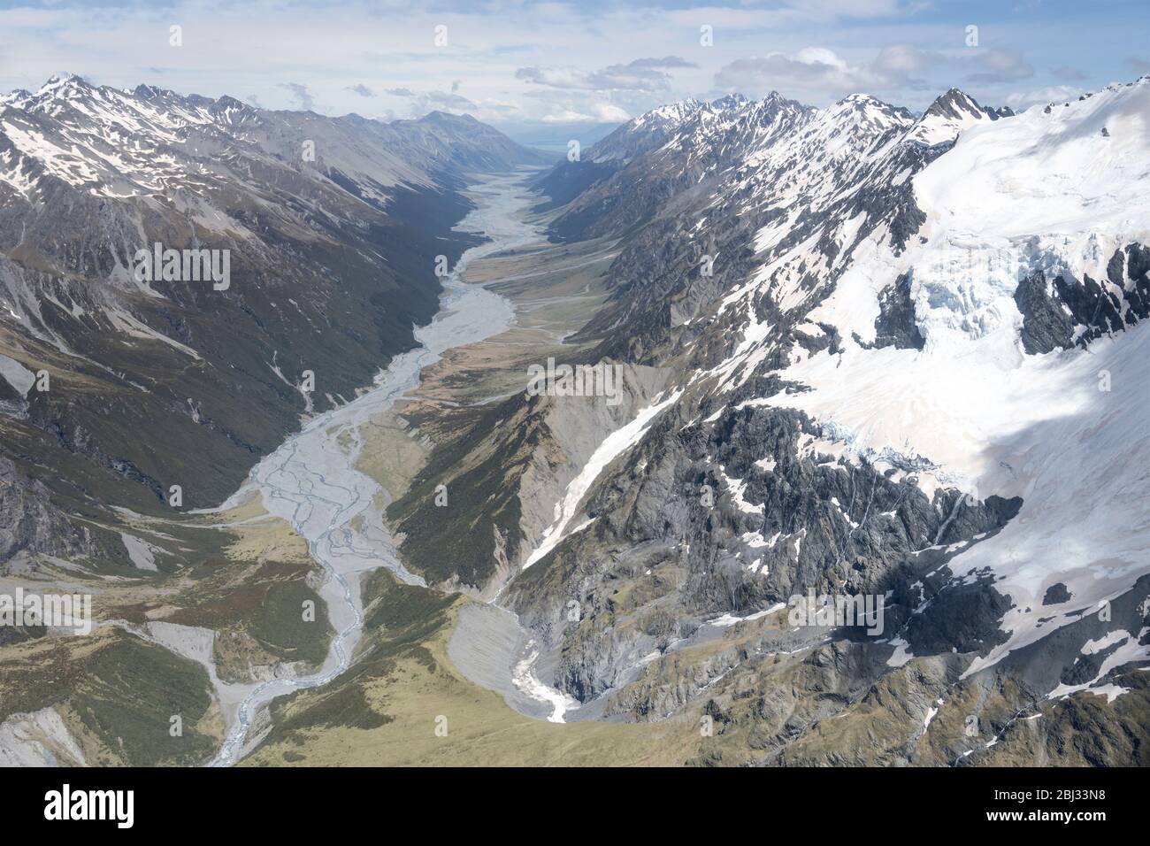 aerial, from a glider, with snow landslides of Selwyn glacier and Dobson river valley, shot in bright spring light from north, Canterbury, South Islan Stock Photo