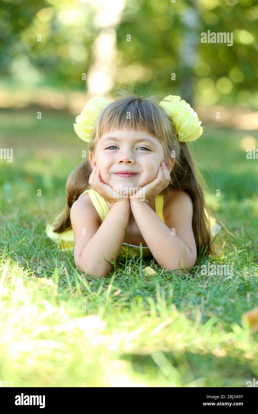 Little girl on grass outside closeup Stock Photo - Alamy