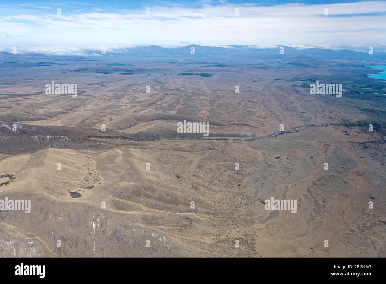 aerial, from a glider, of barren flat upland near Tekapo, shot in bright spring light from north, Canterbury, South Island, New Zealand Stock Photo