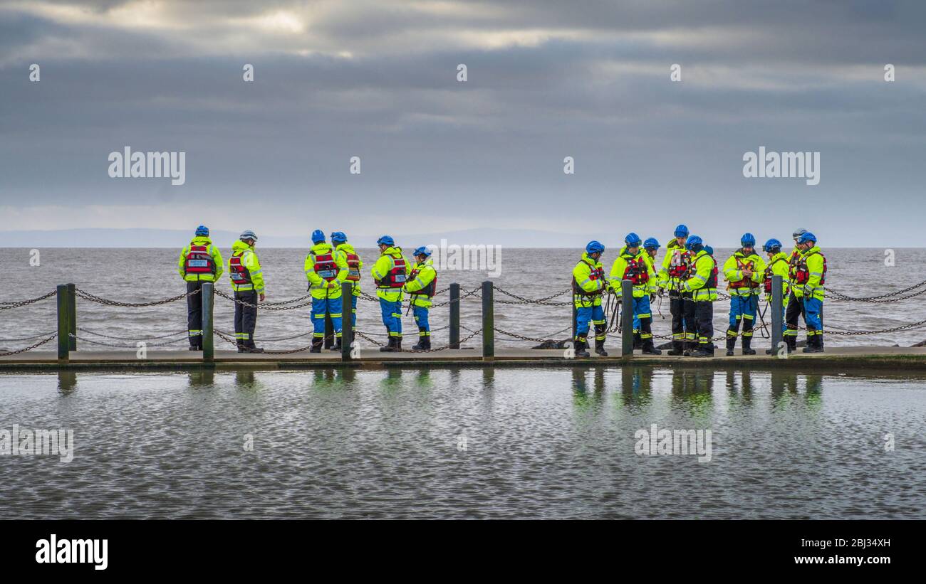 Coastguard Rescue members during a training exercise on the sea Wall to Marine Lake at Weston Super Mare. Stock Photo