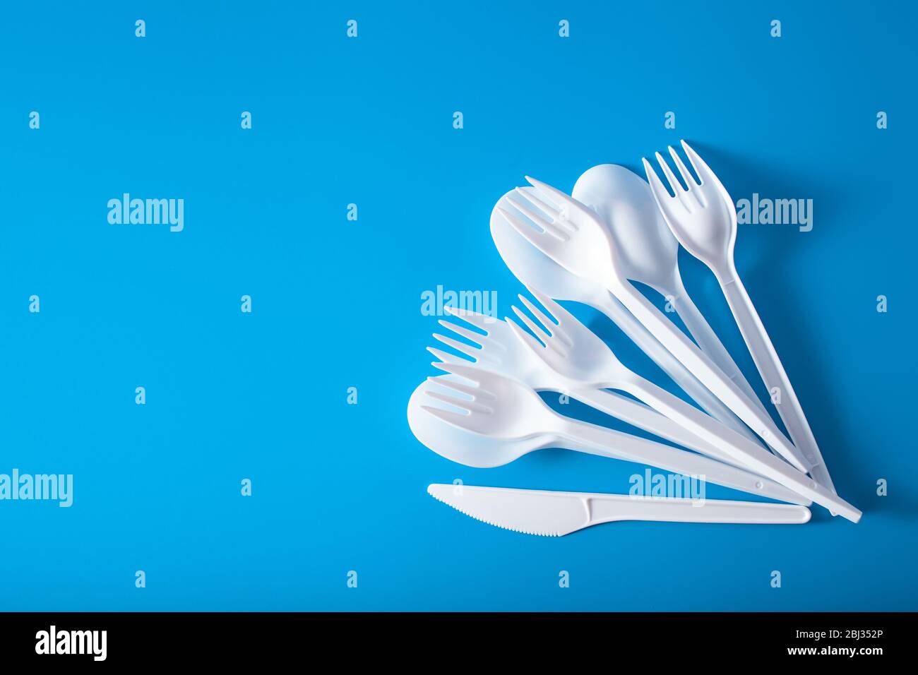 single use plastic forks, spoons. concept of recycling plastic, plastic