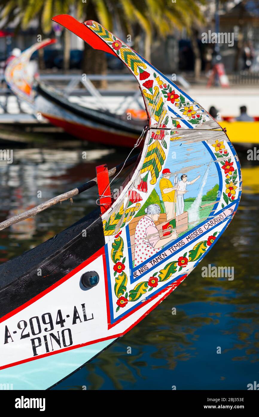 Traditional brightly painted gondola style moliceiro canal boat with scene painted on prow in Aveiro, Portugal Stock Photo