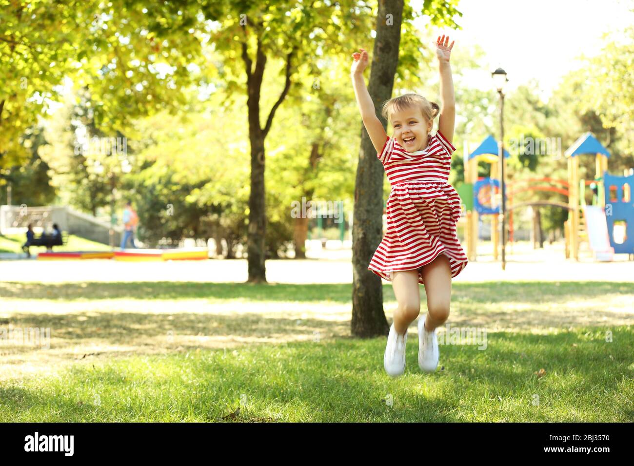 Little happy girl playing in park near the playground Stock Photo - Alamy