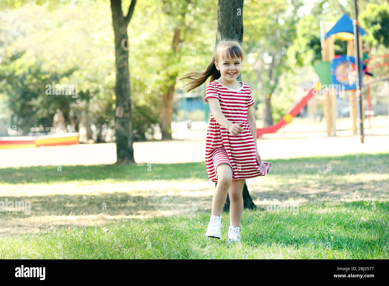 Little happy girl playing in park near the playground Stock Photo - Alamy