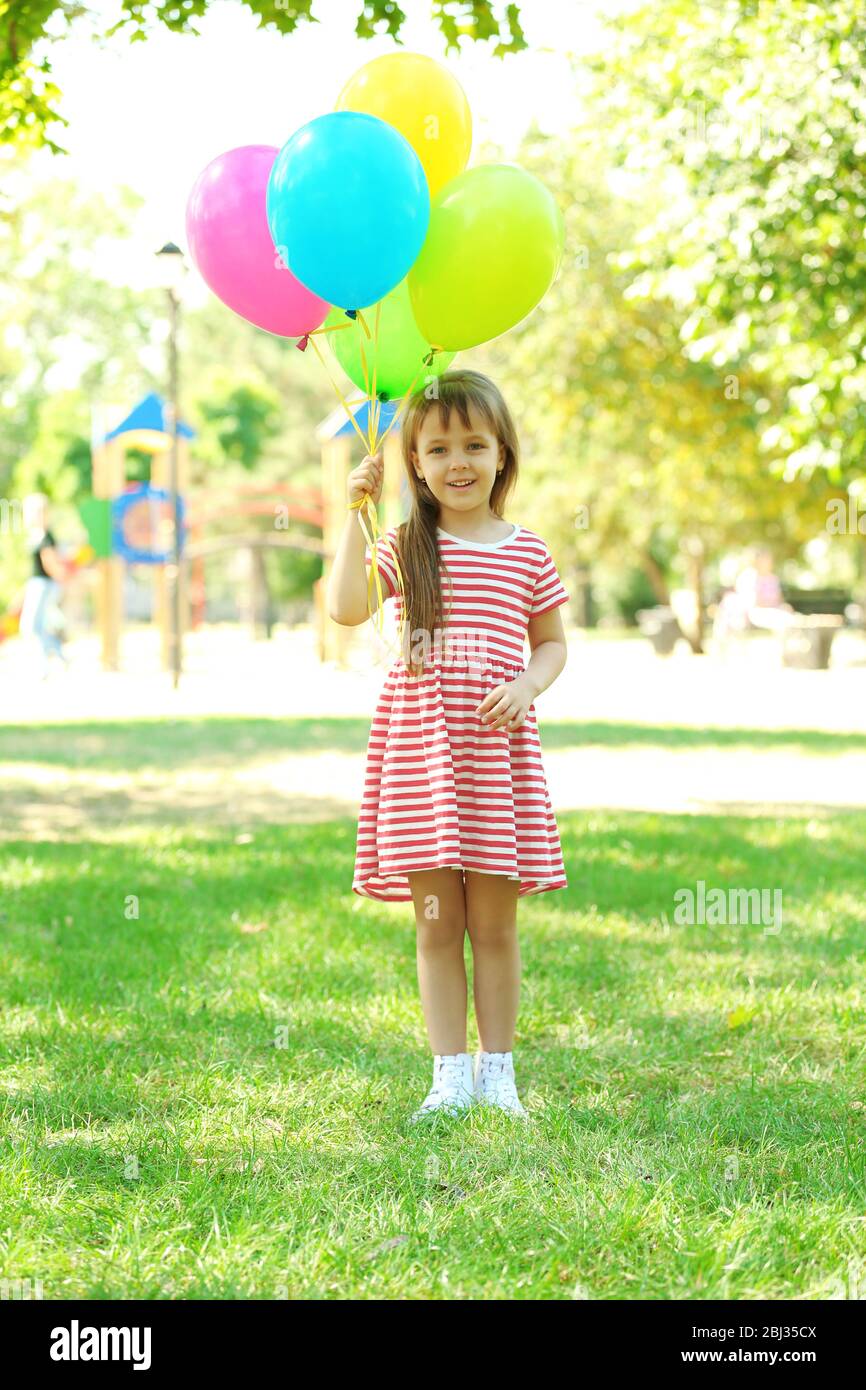 Little girl with balloons in the park Stock Photo Alamy