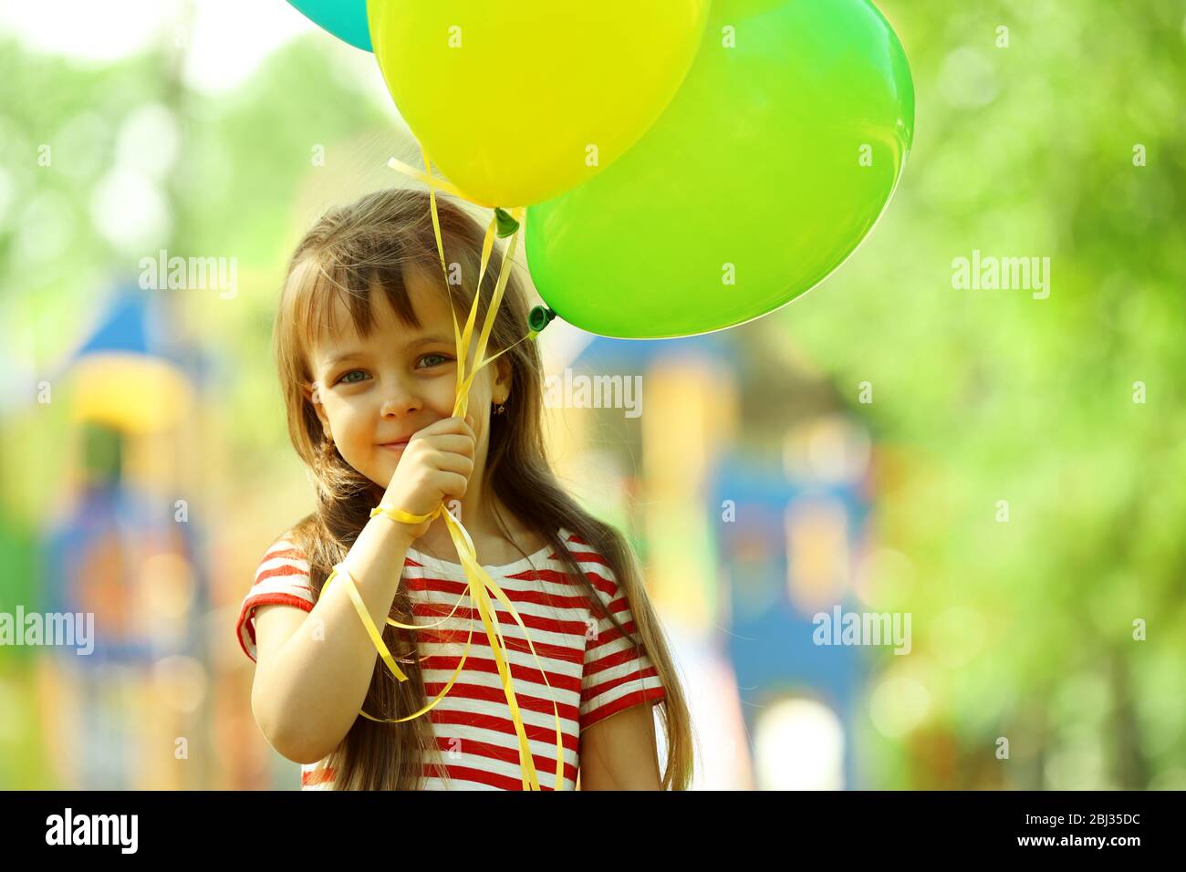 Little girl with balloons in the park Stock Photo - Alamy