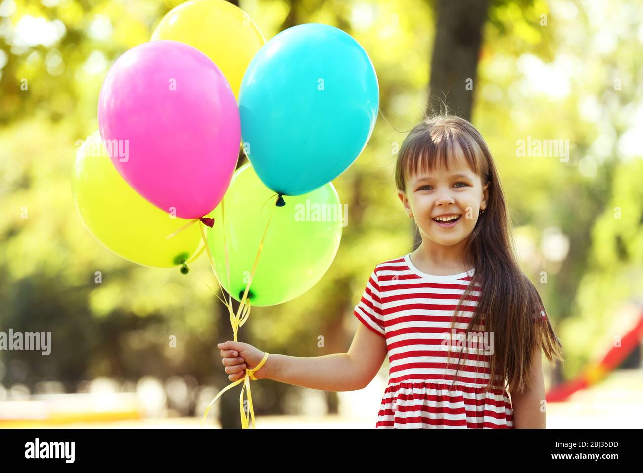 Little girl with balloons in the park Stock Photo Alamy