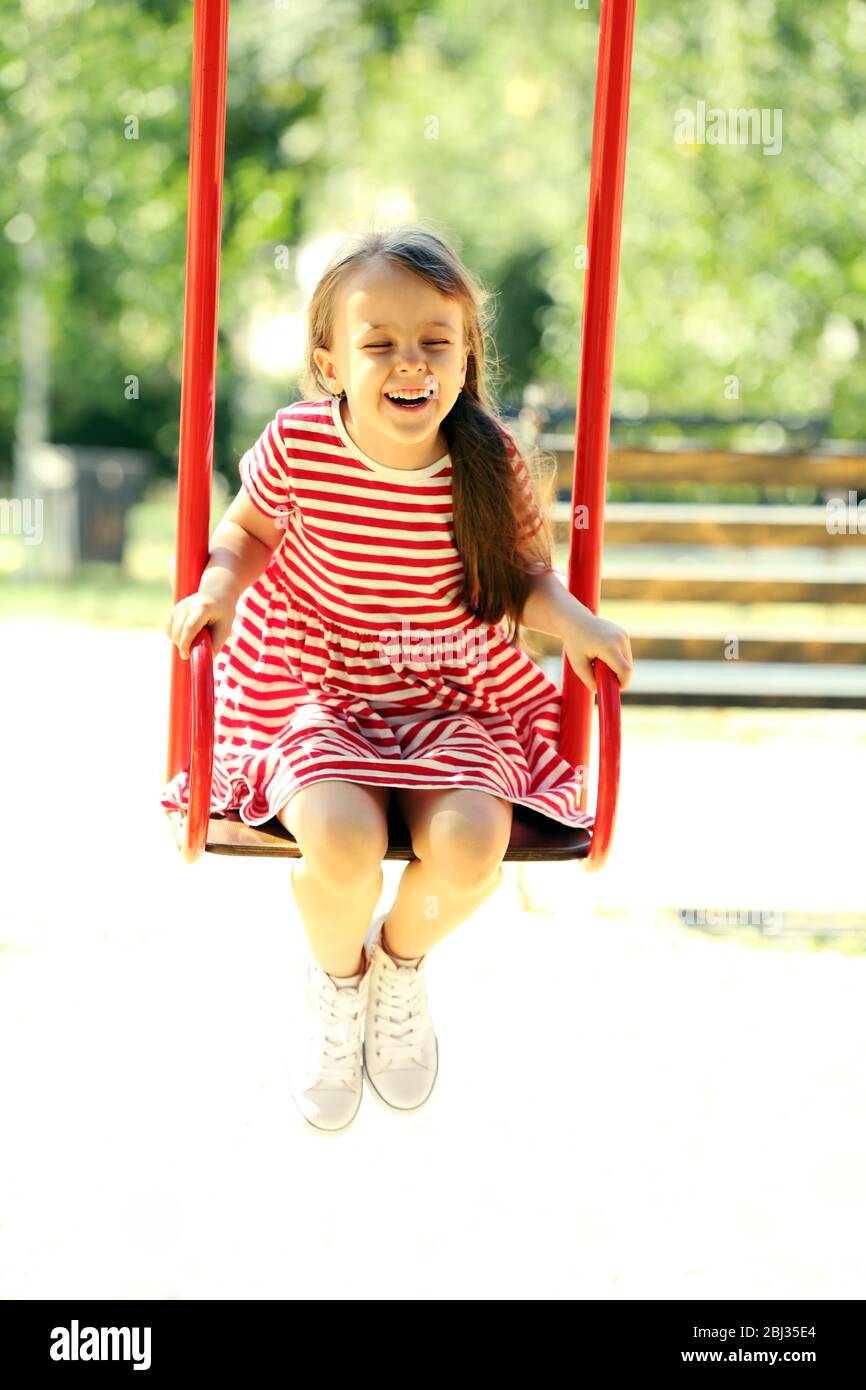 Little girl on swing in the park Stock Photo
