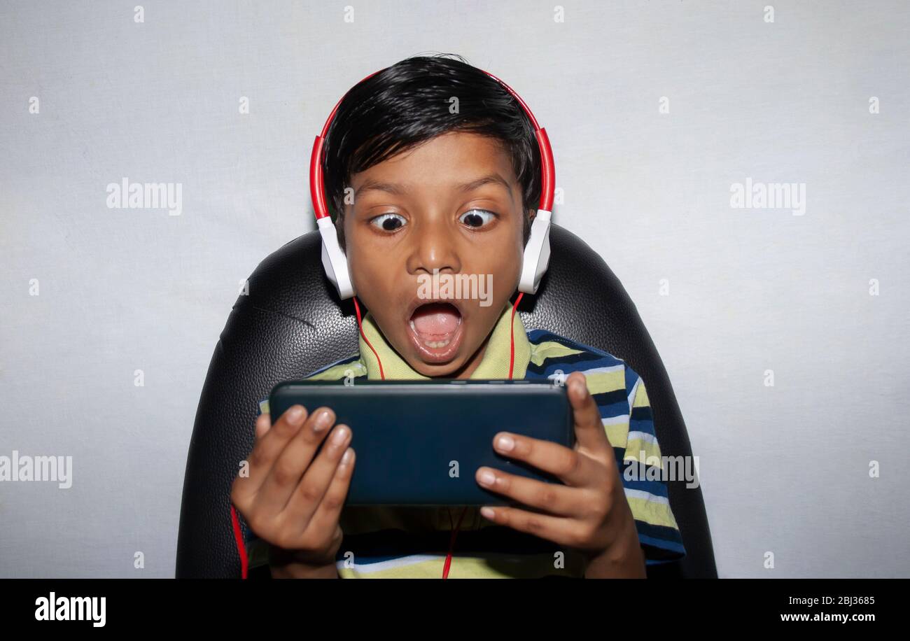 Boy Shocked Face on Smart phone watching movie Stock Photo - Alamy