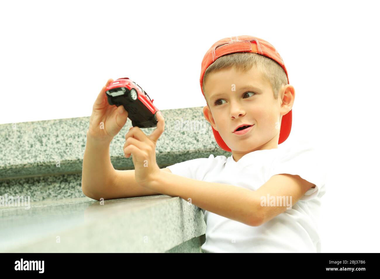 Little boy playing with toy car outside Stock Photo - Alamy