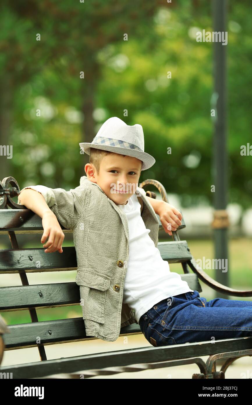 Little boy on bench in the park Stock Photo - Alamy