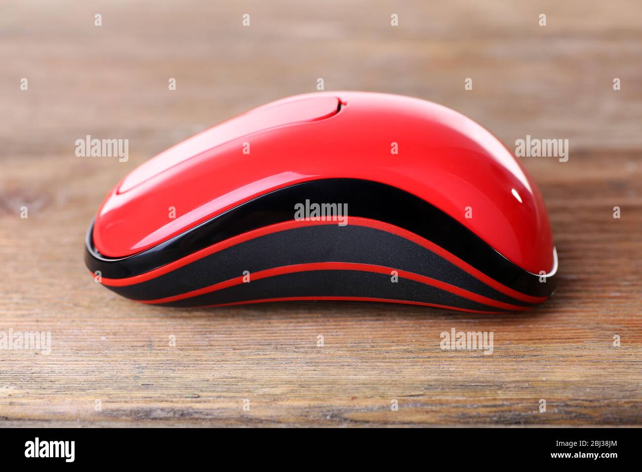 Wireless computer mouse on wooden background Stock Photo