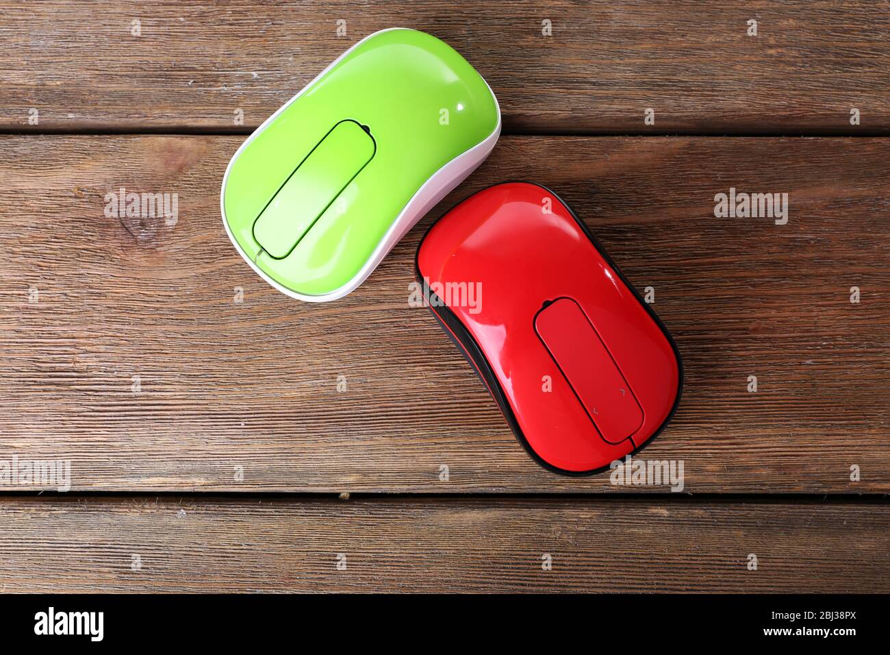Wireless computer mouses on wooden background Stock Photo