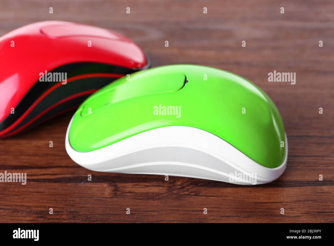 Wireless computer mouses on wooden background Stock Photo