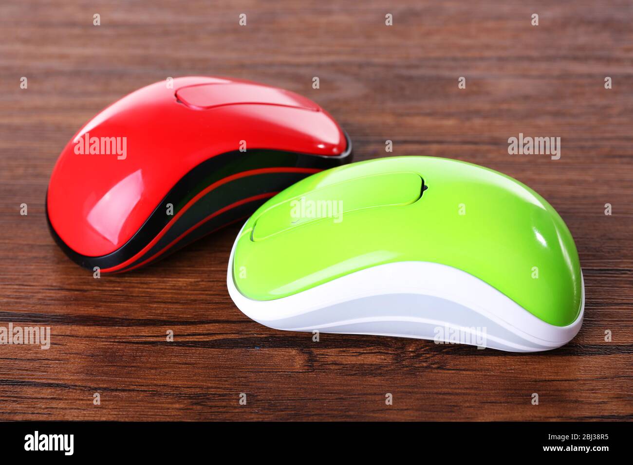 Wireless computer mouses on wooden background Stock Photo
