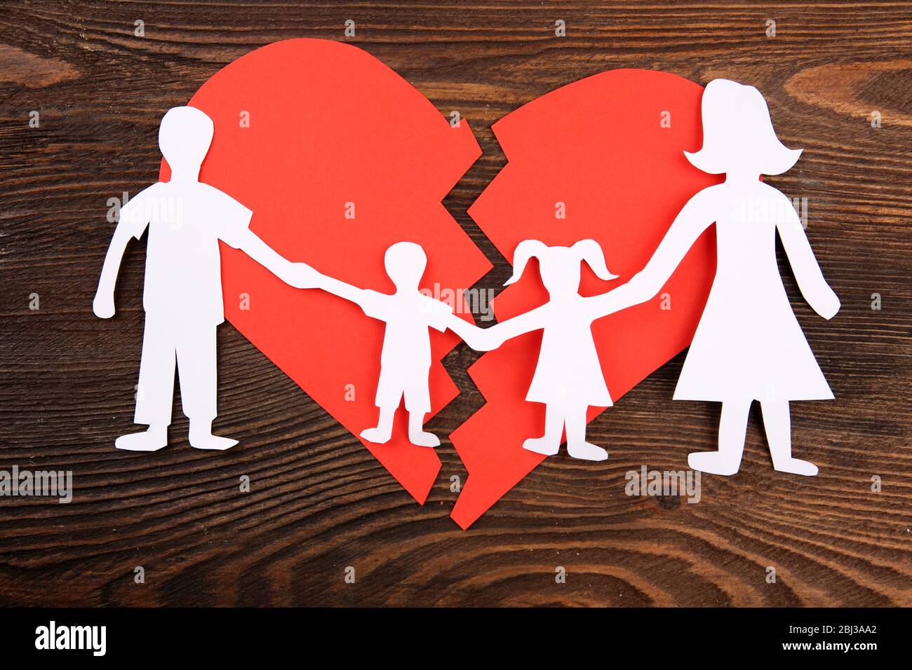 Paper Cutout Silhouette Of A Family Split Apart On A Paper Heart ...