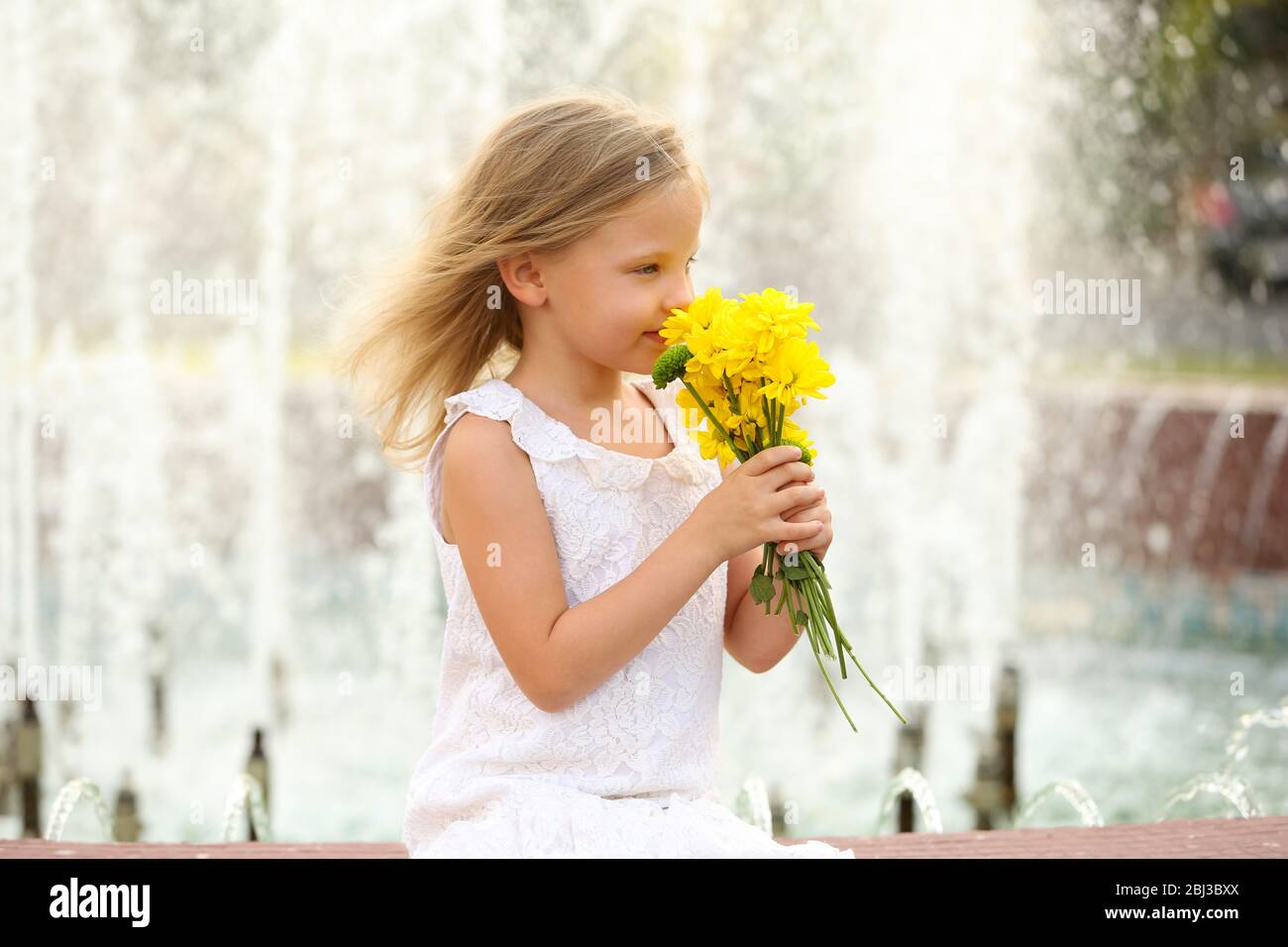 Happy girl on fountain background Stock Photo - Alamy