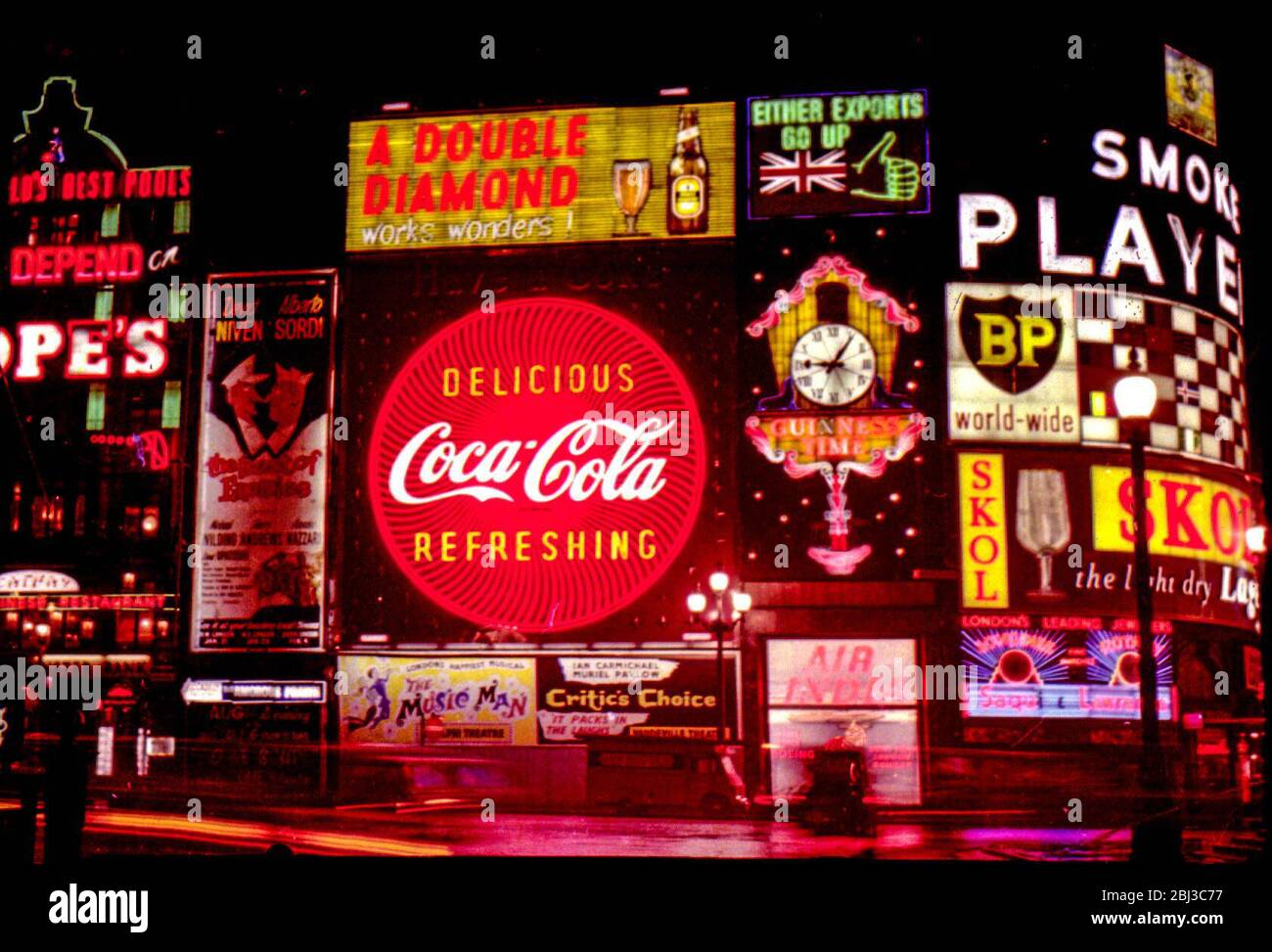 The neon signs of Piccadilly Circus in the West End of London advertising the popular products of the 1960s, taken in 1961. Stock Photo