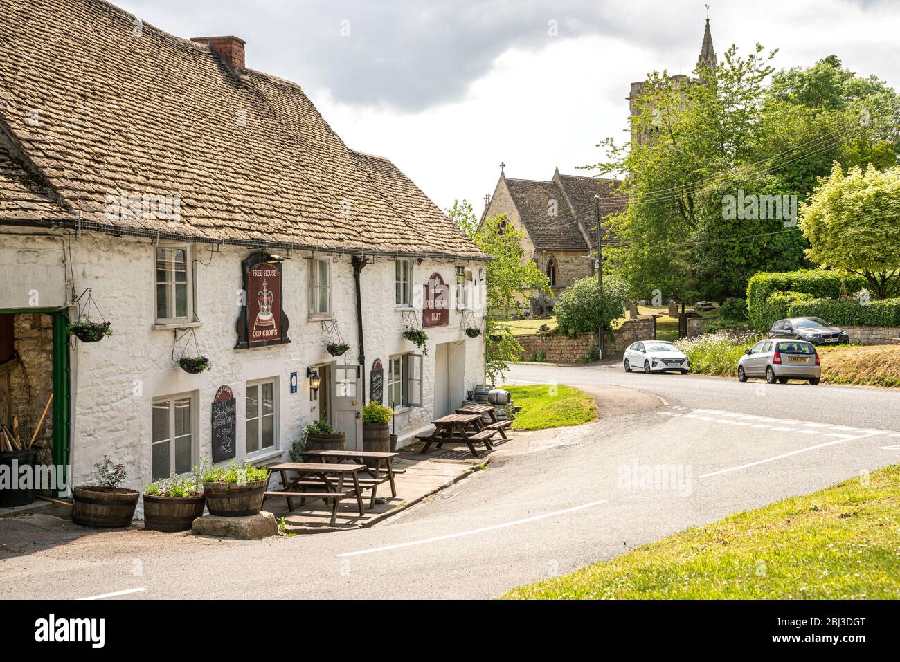 The Cotswold village of Uley with the Old Crown country pub and The Church of Saint Giles, United Kingdom Stock Photo
