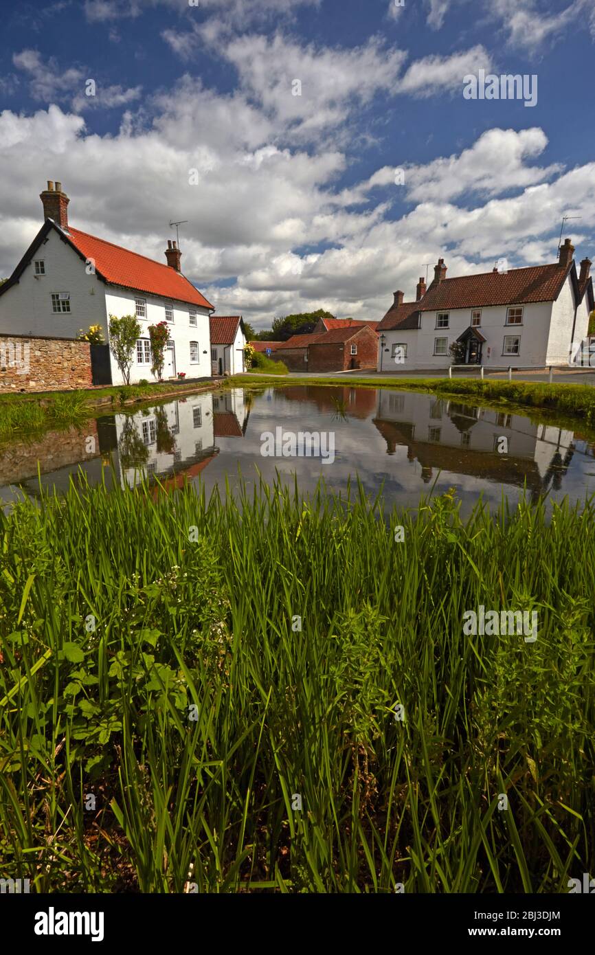 Cottages at Burton reflected in the village pond Stock Photo Alamy