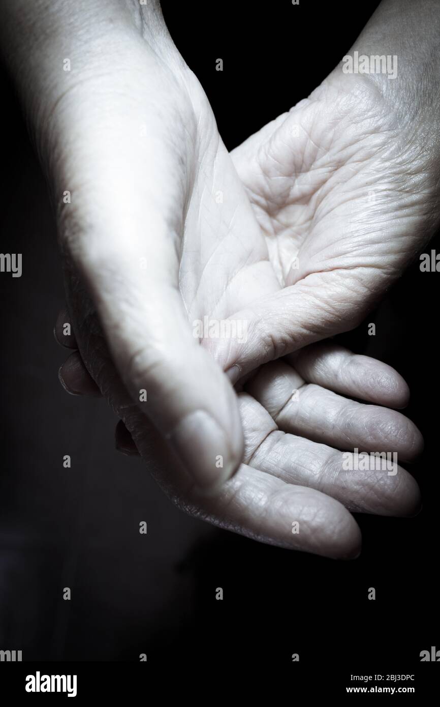 Hands of elderly woman doing a selfmassage. Manual physiotherapy Stock Photo