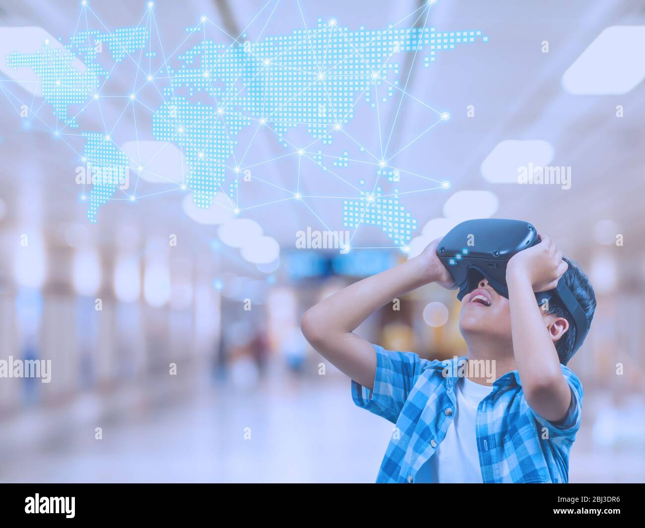 Boy Wearing Virtual Reality Glasses In Modern Interior Design Studio And Trying To Touch Dots Network And Earth Map Or Something Appear In Vr With Exc Stock Photo Alamy