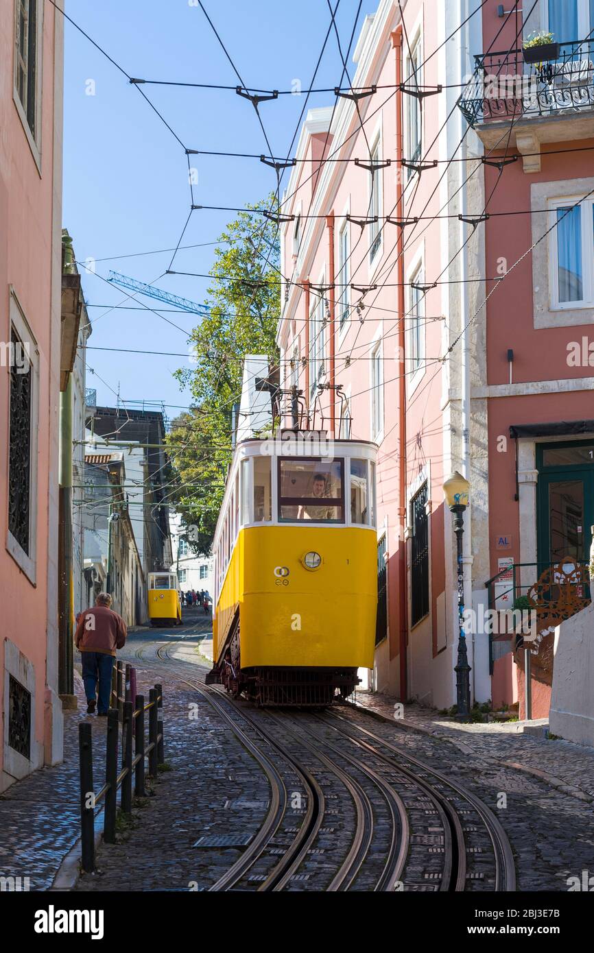 Gloria Funicular - Elevador Gloria - for local people and tourists on tram tracks up steep hill links Barro Alto with Chiado in Lisbon, Portugal Stock Photo