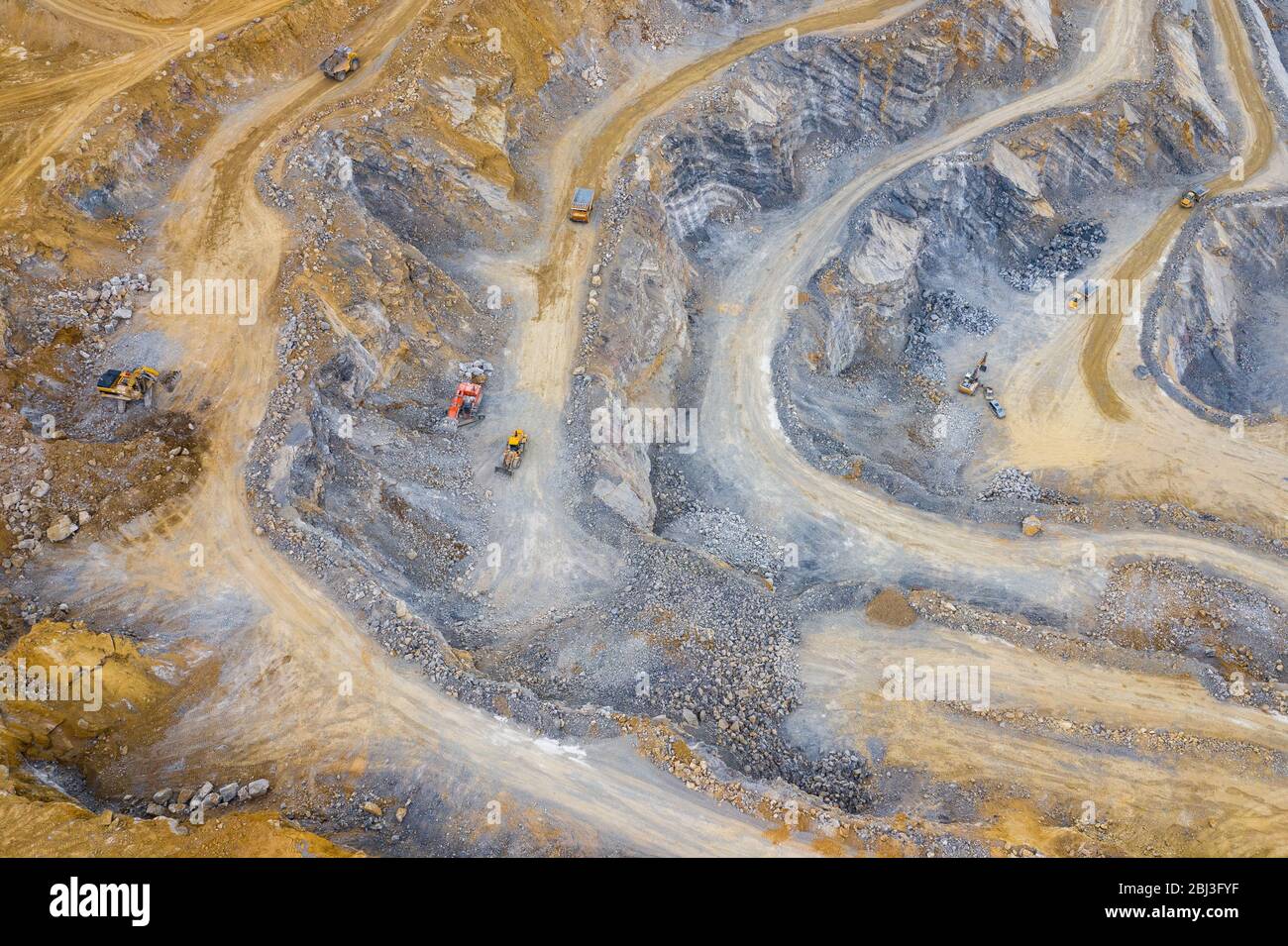 Mining from above. Industrial terraces on open pit  mineral mine. Aerial view of opencast mining. Dolomite Mine Excavation. Extractive industry. Giant Stock Photo