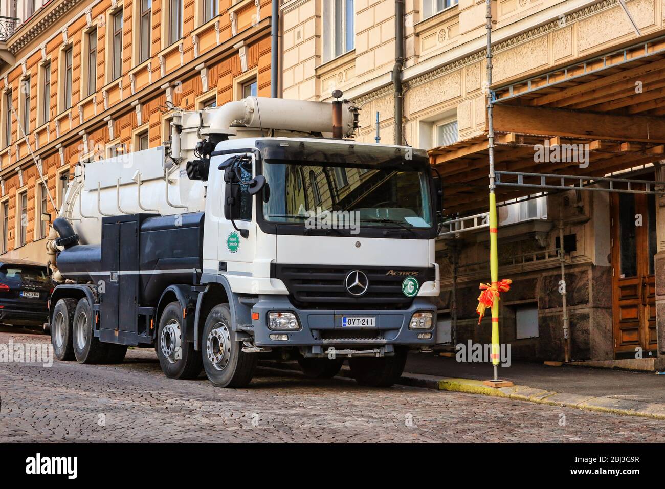 White Vacu-Press 8000 truck by city work site. Vacu-press is suitable for suction and blowing of dry and wet material. Helsinki, Finland. Apr 28, 20. Stock Photo