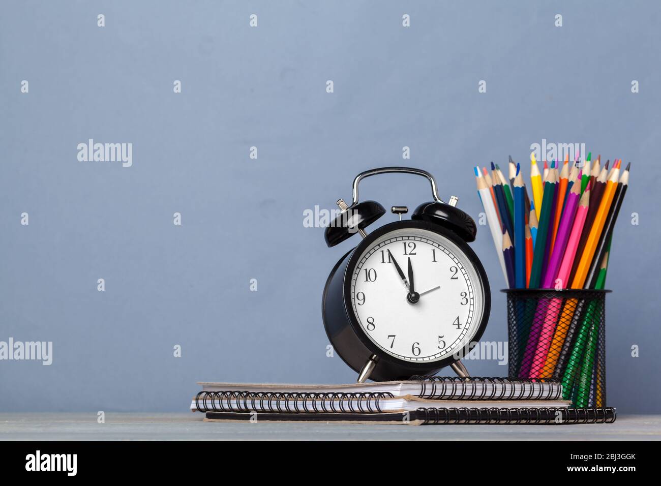 Back to school background with books and alarm clock Stock Photo - Alamy