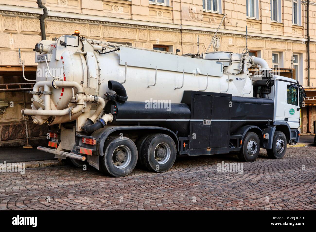 White Vacu-Press 8000 truck by city work site. Vacu-press is suitable for suction and blowing of dry and wet material. Helsinki, Finland. Apr 28, 20. Stock Photo