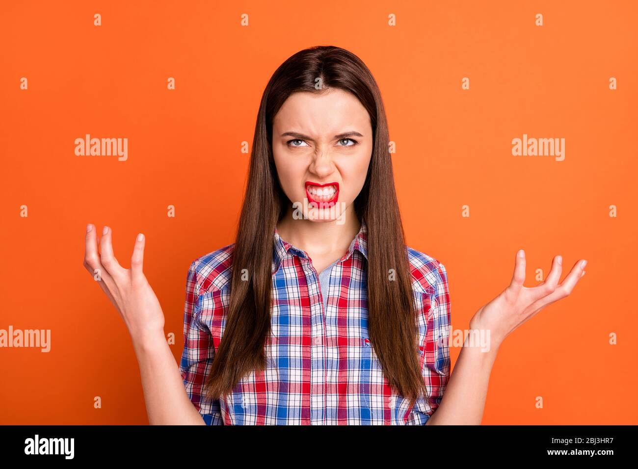 Photo of attractive but evil lady look empty space rage raising arms ...