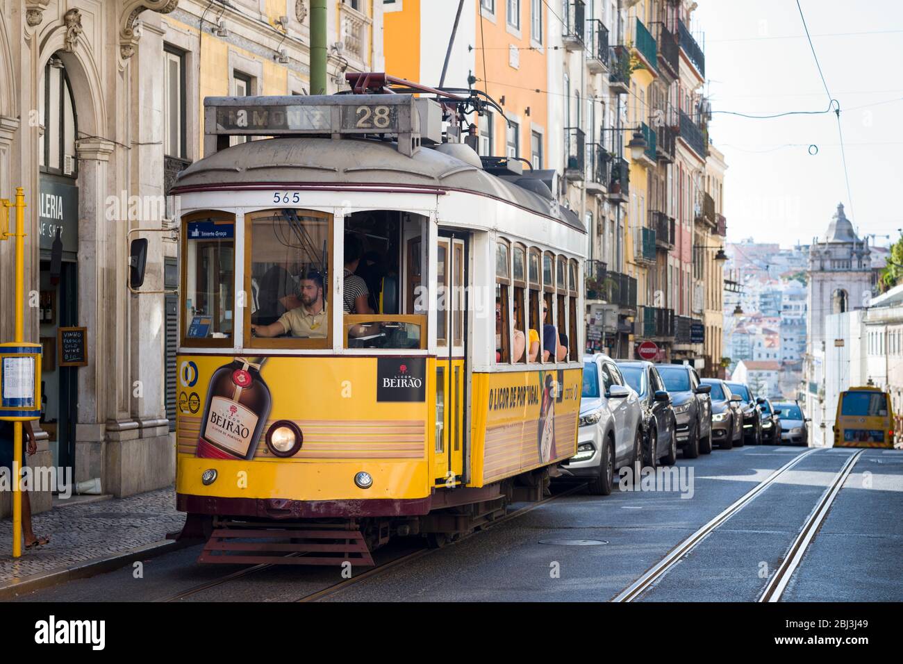 Famous tram no. 28 carrying local people and tourists on tram tracks ii Praca Luis de Camoes n City of Lisbon, Portugal Stock Photo