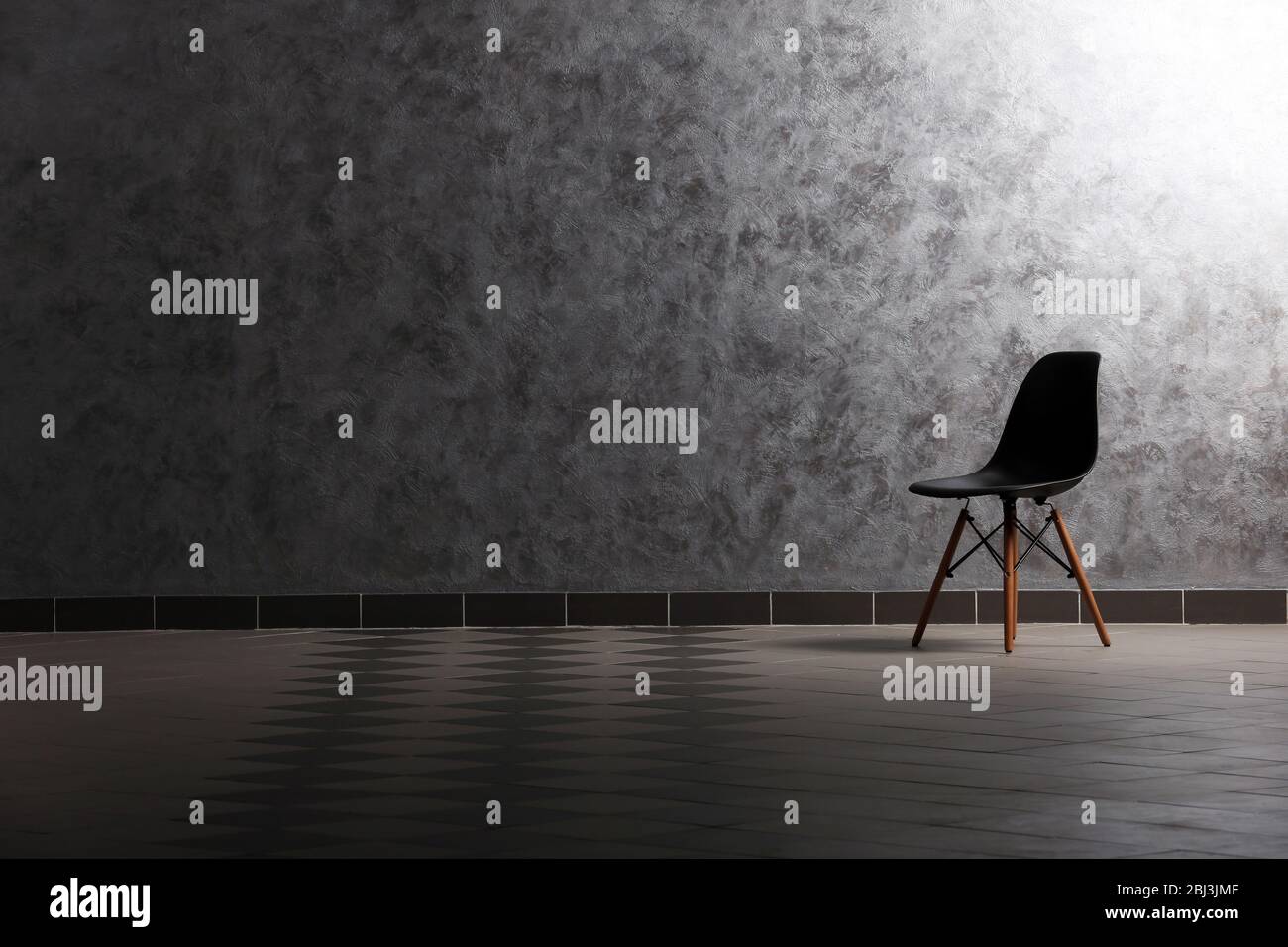 Chair on grey wall background Stock Photo - Alamy