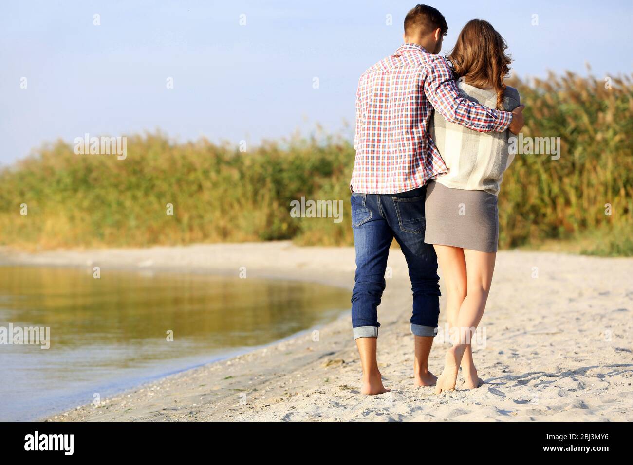 Young couple on the riverside Stock Photo - Alamy