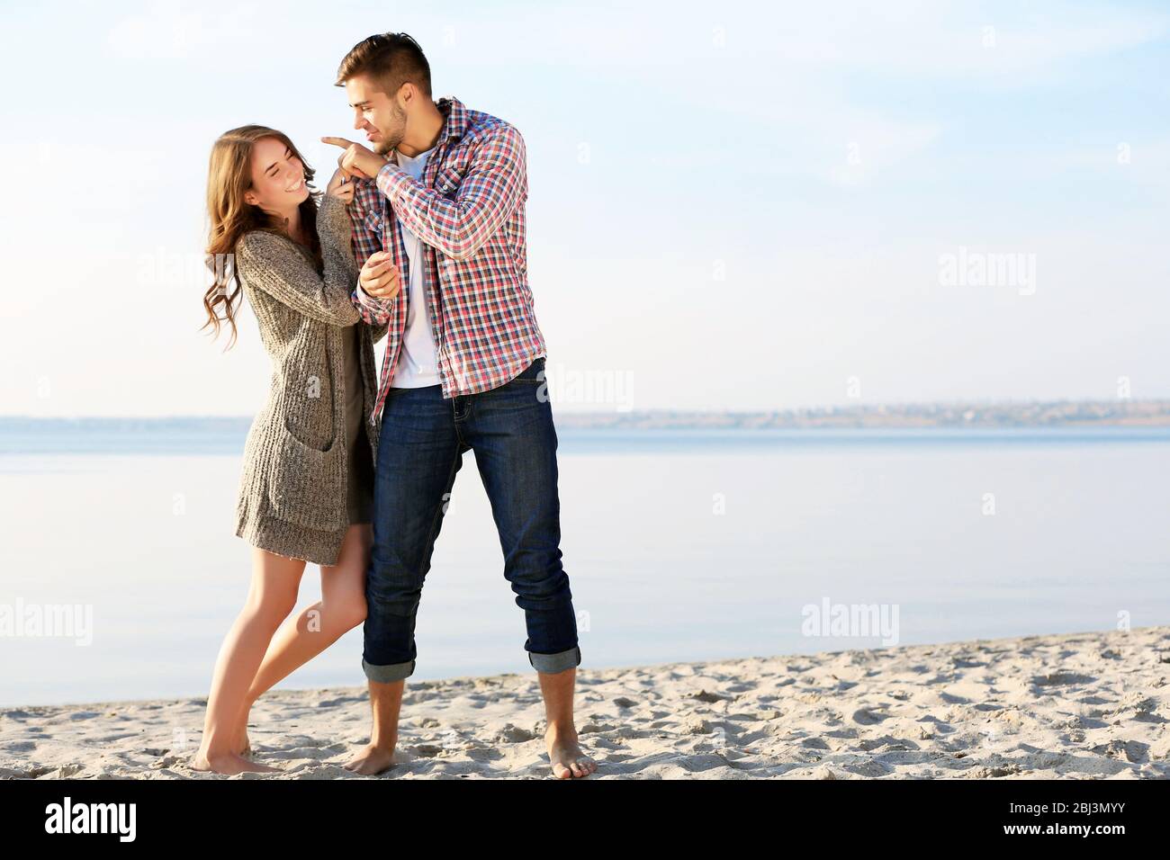 Young couple on the riverside Stock Photo - Alamy