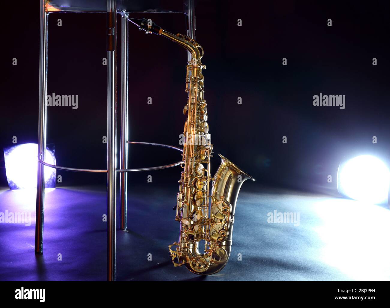Beautiful golden saxophone near bar stool on a scene Stock Photo Alamy