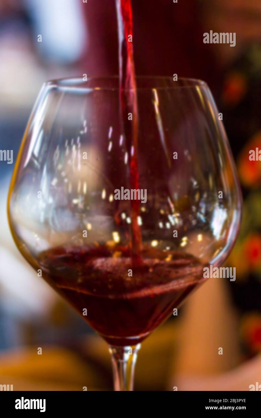 Abstract blur. Pours red wine Stock Photo