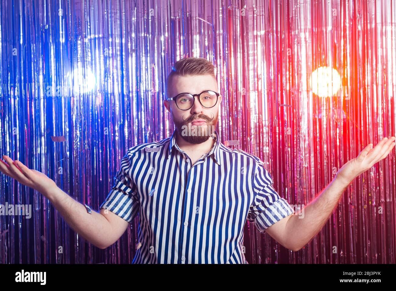 Party, carnival, holidays and fun concept Fancy man throws confetti