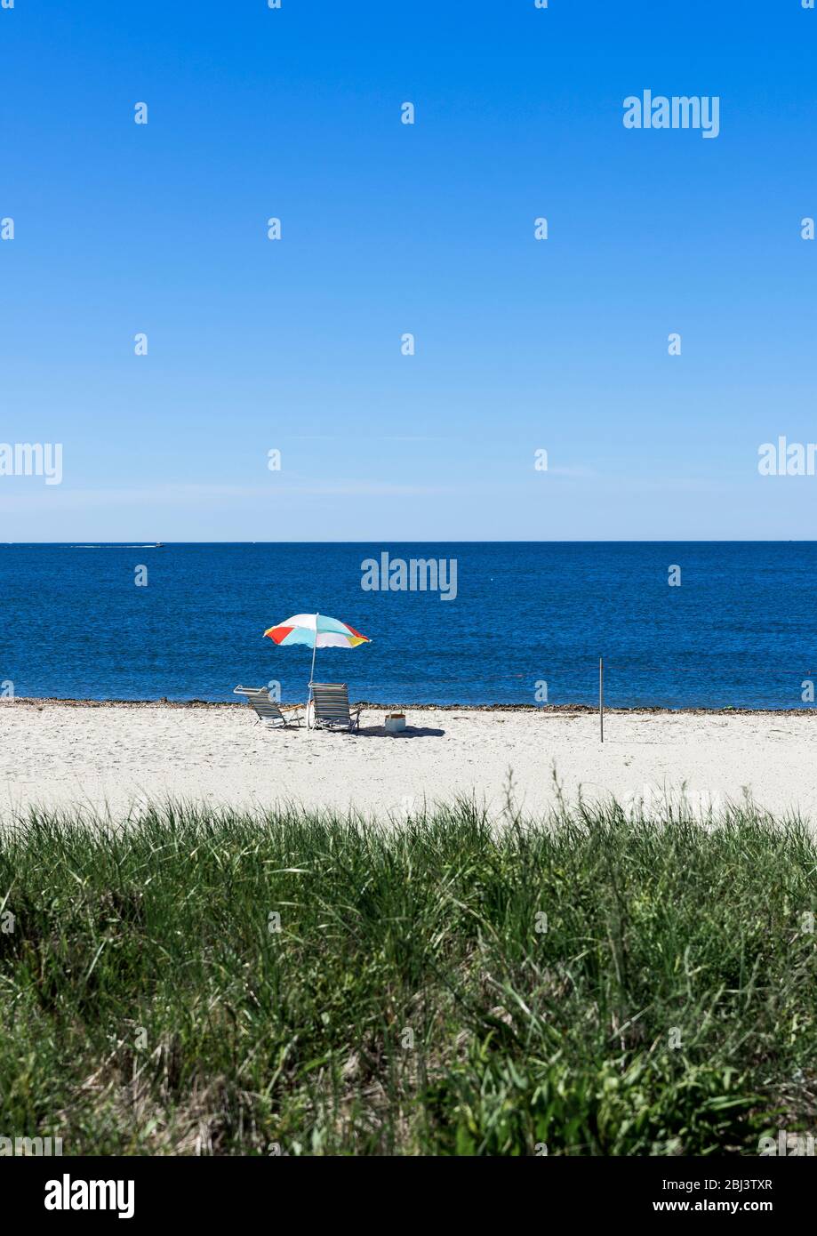 Beach umbrella and chairs on West Dennis Beach at Cape Cod in Massachusetts. Stock Photo