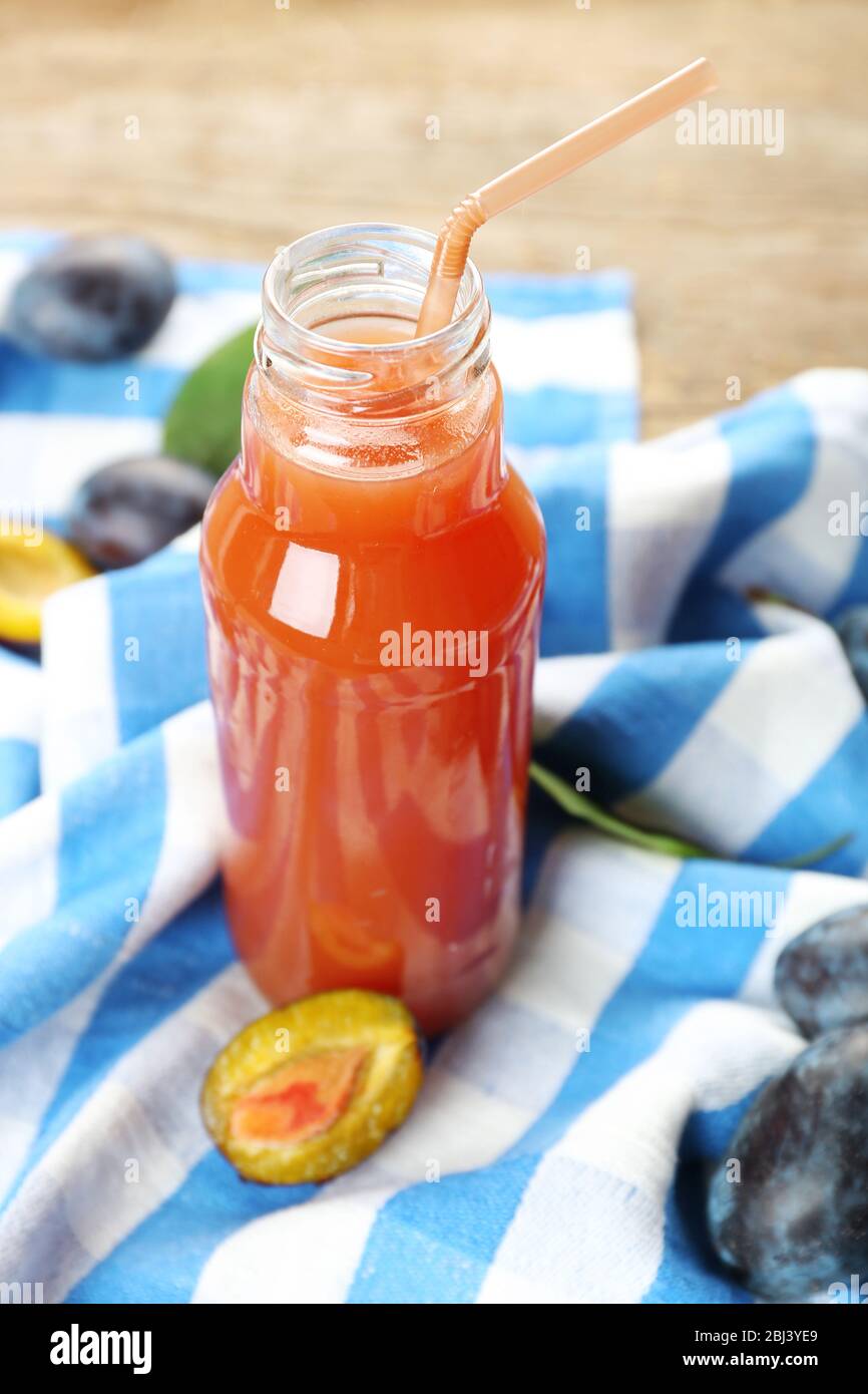 Plum Juice in a glass bottle with fresh fruits Stock Photo Alamy