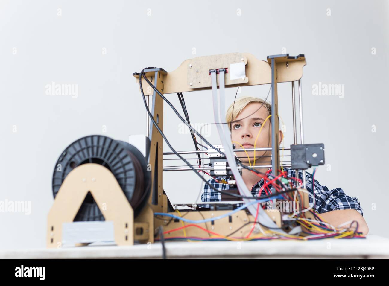 Education, children, technology concept - teen boy is printing on 3d ...