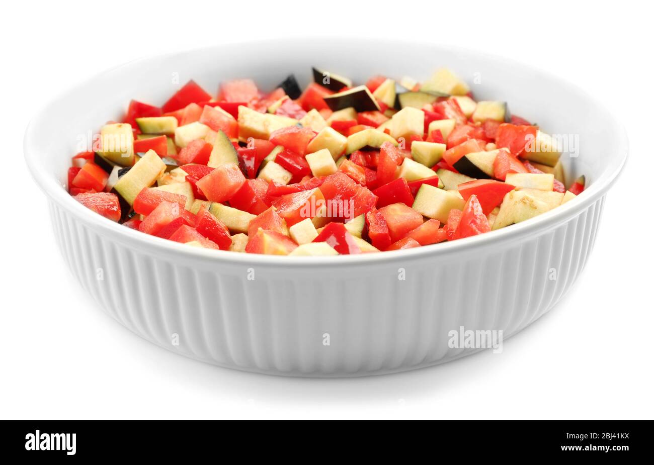 Ratatouille, stewed vegetable dish with tomatoes, zucchini, eggplant before cooking, isolated on white Stock Photo