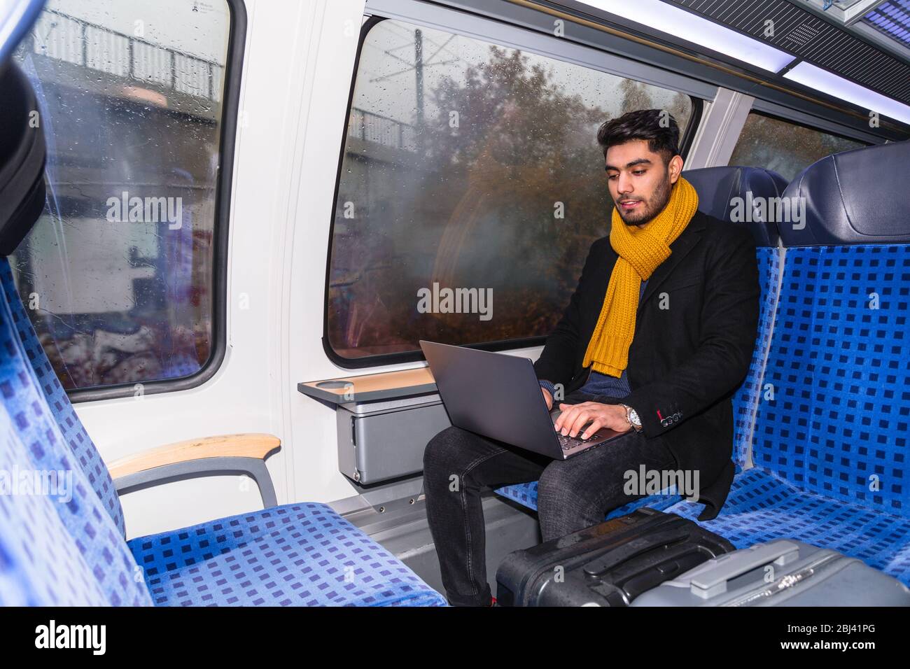 Businessman works on train using hi-res stock photography and images ...